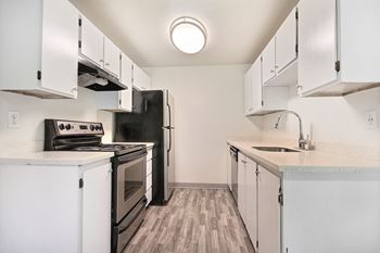 the preserve at ballantyne commons apartment kitchen with white cabinets and black appliances